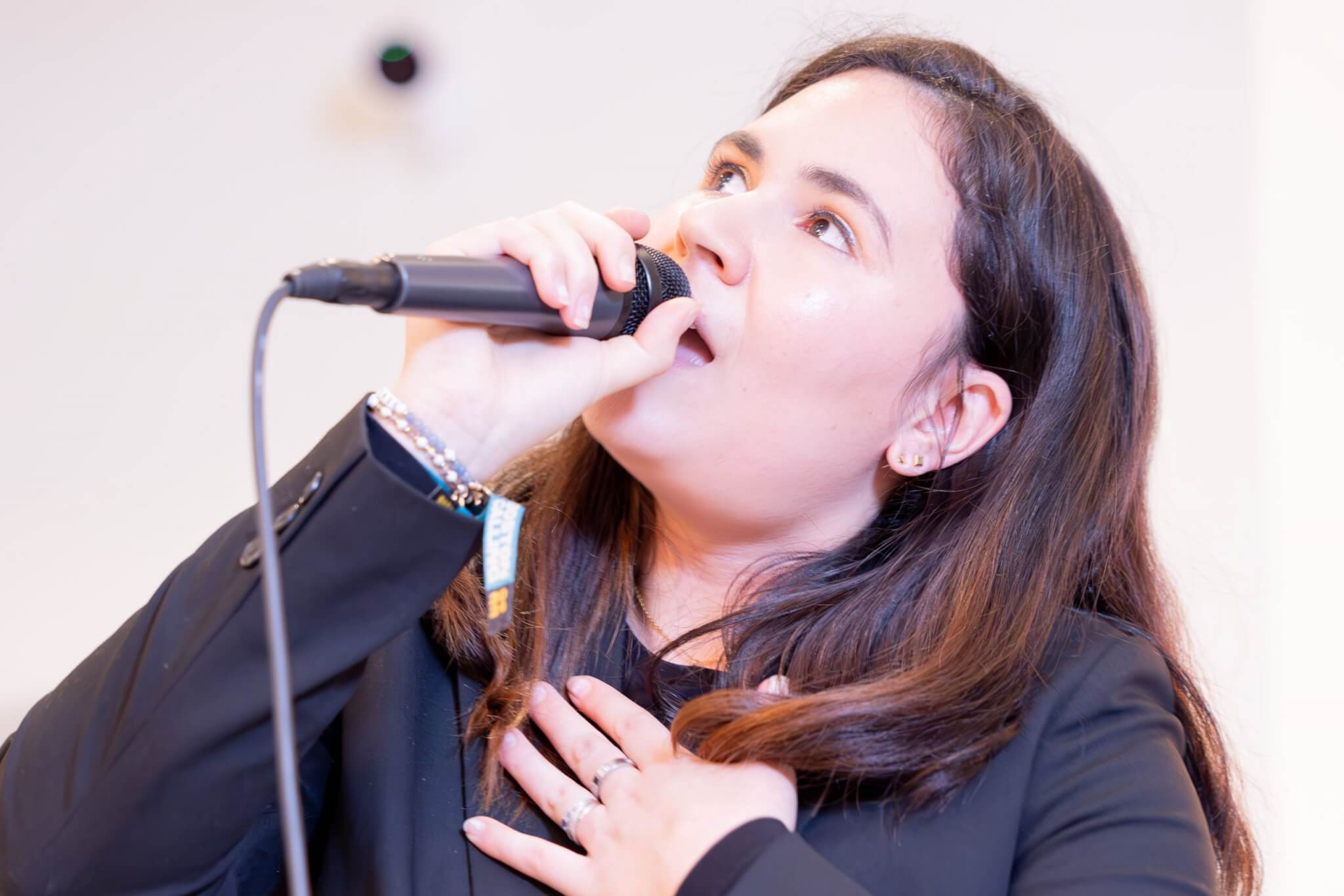 Vocal coach singing her song at a happy hour performance